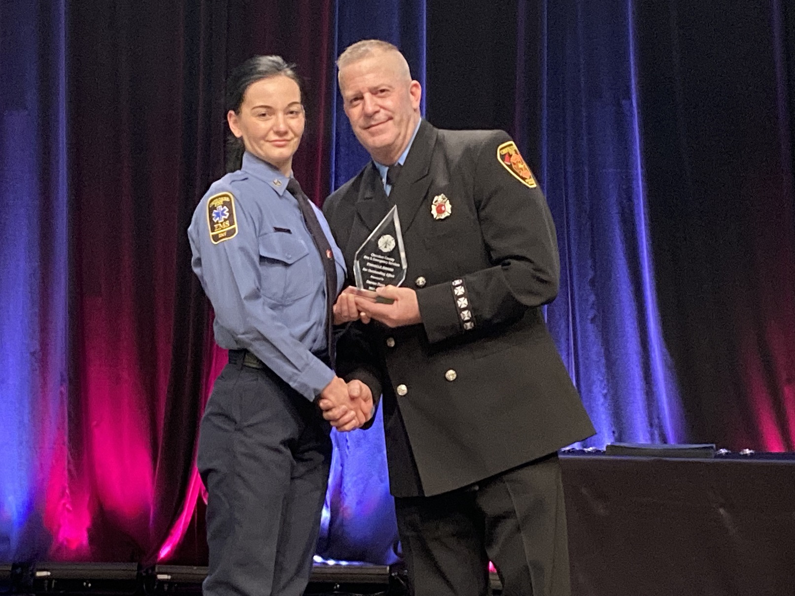 Darian Prem (left) receives the Pinnacle Award for striving to "reach to the top."