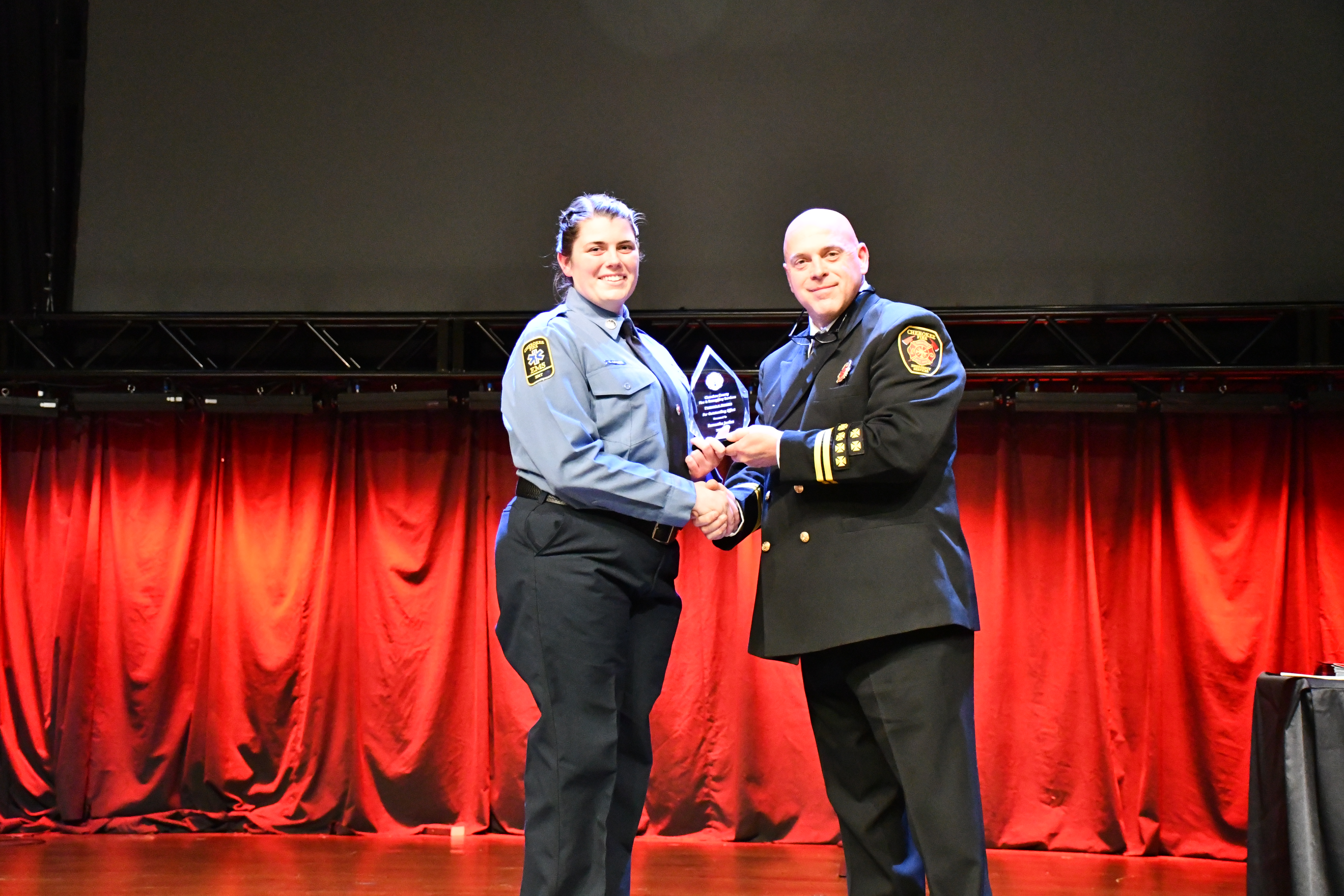 Samantha Jordan receives the Pinnacle Award from Chief Tom Pelletier
