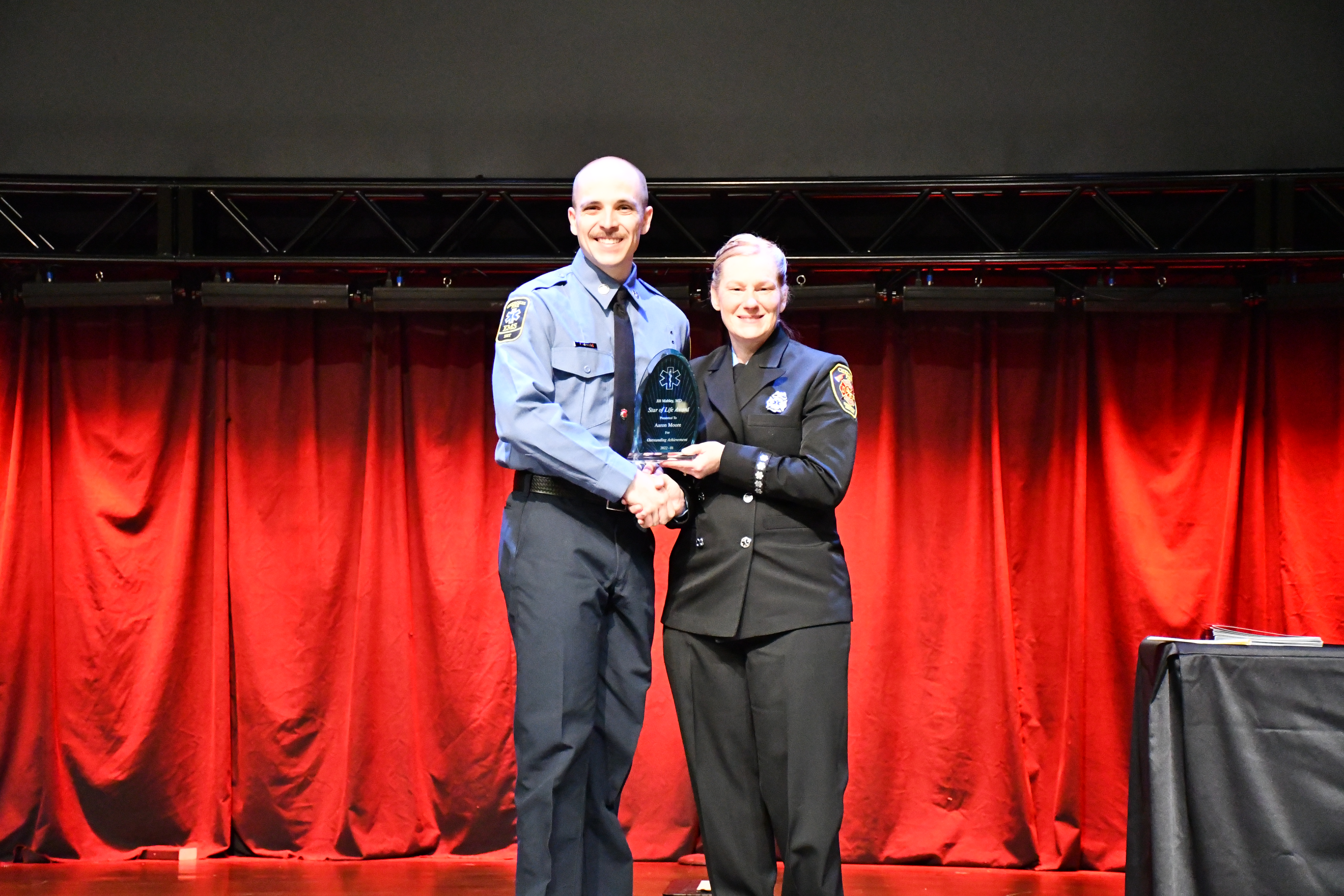 Aaron Moore is presented the Jill Mabley Star of Life Award by Instructor Sandra Johnson