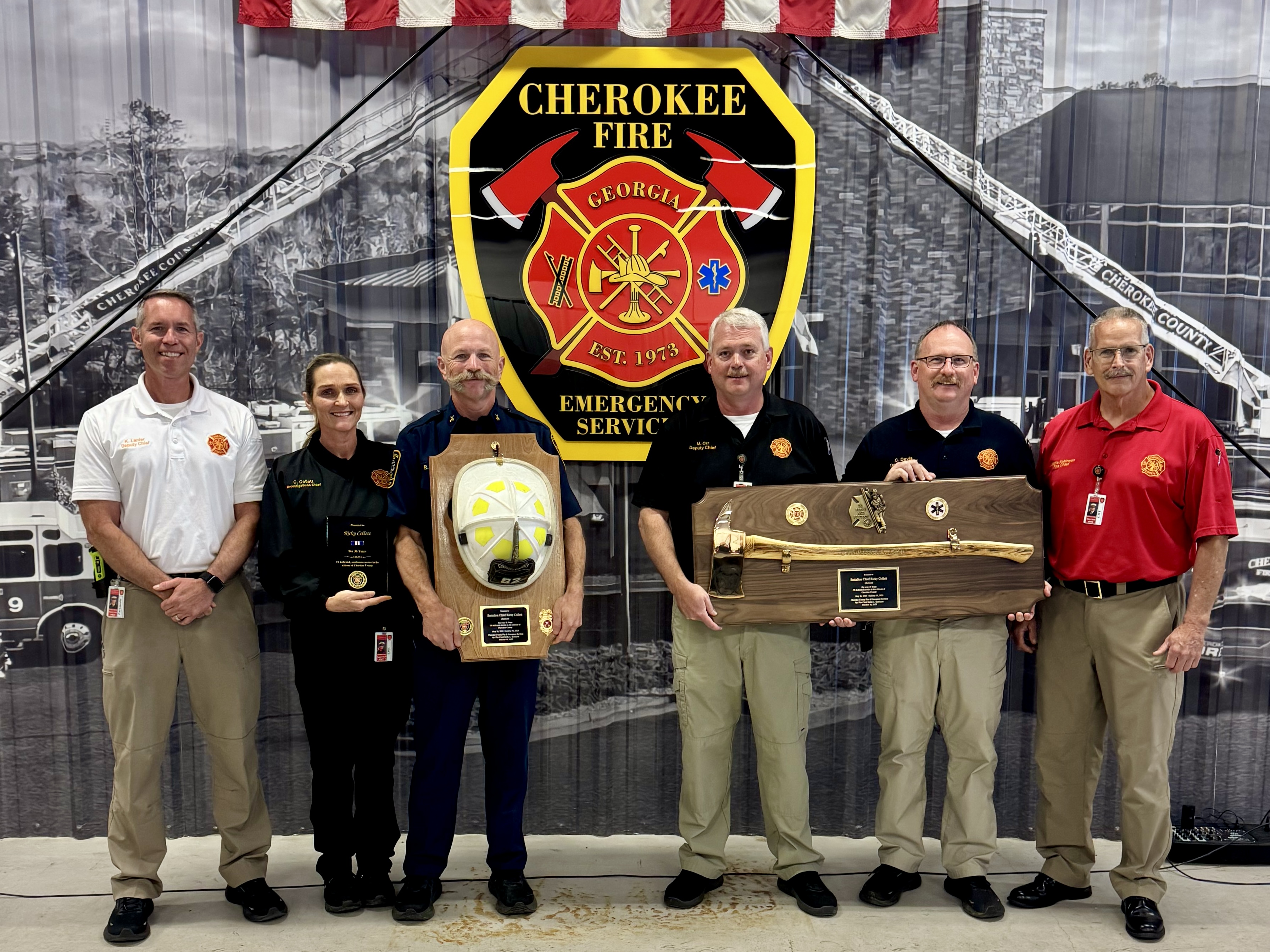 Fire Chief Eddie Robinson and other members of the command staff present Chief Ricky Collett with plaques honoring his time with CCFES.