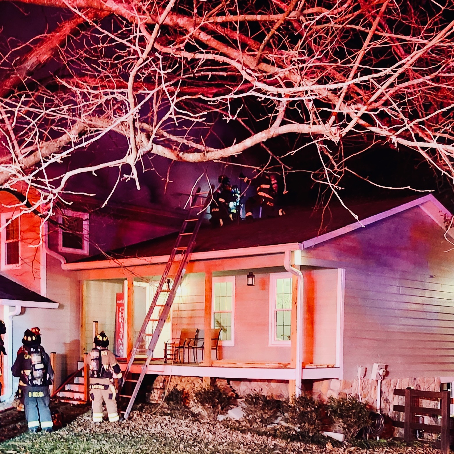 Firefighters work at the scene of a structure fire.