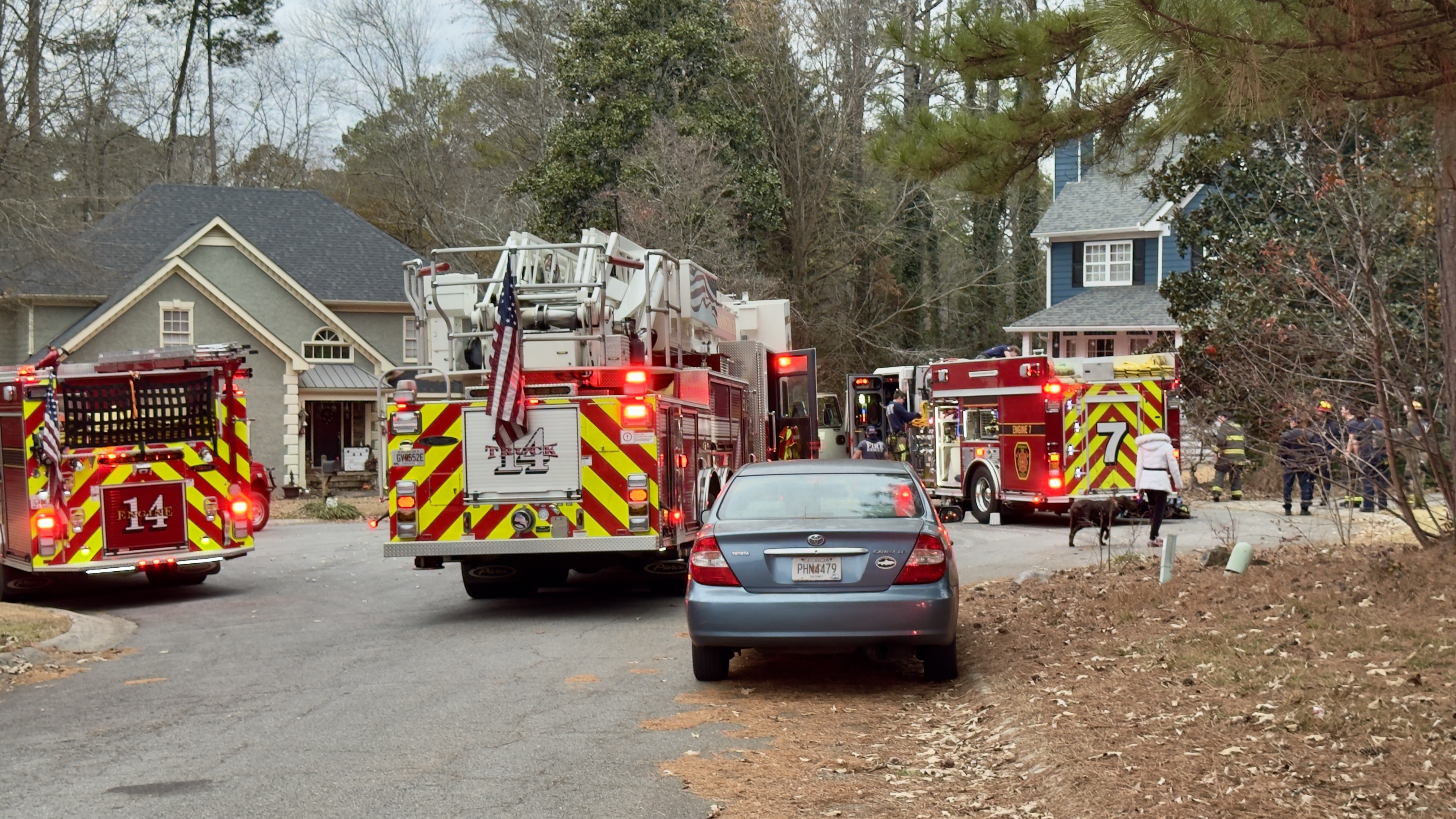 Fire apparatus positioned in front of house fire. 