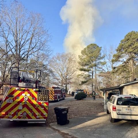 Firefighters work at the scene of a structure fire