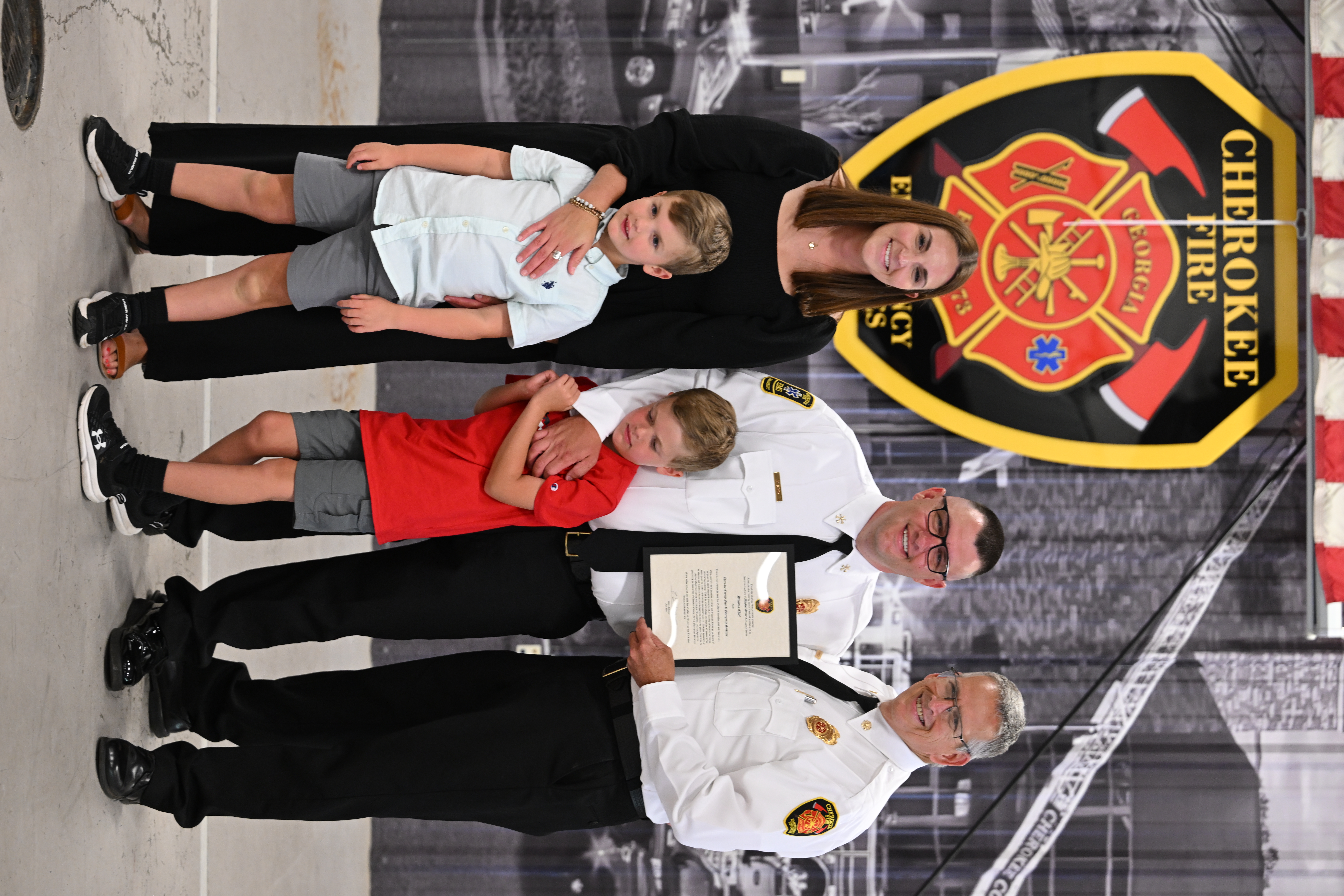 Chief Robinson congratulates Division Chief Michael Sims and his family. 
